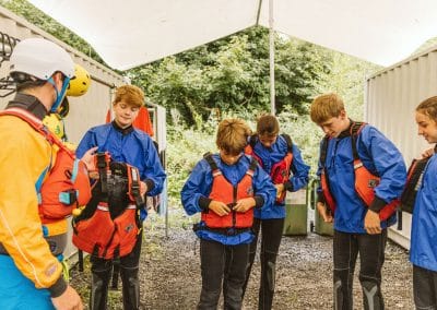 Safety brief and gear check before going on the river with rafting.ie